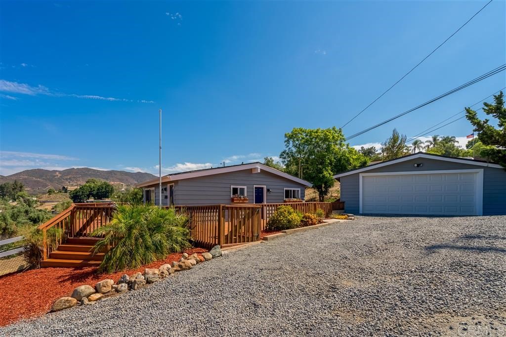 3157 Peg Leg Mine Road Jamul, CA 91935 - Photo 1 of 1 a front view of a house with a yard and garage