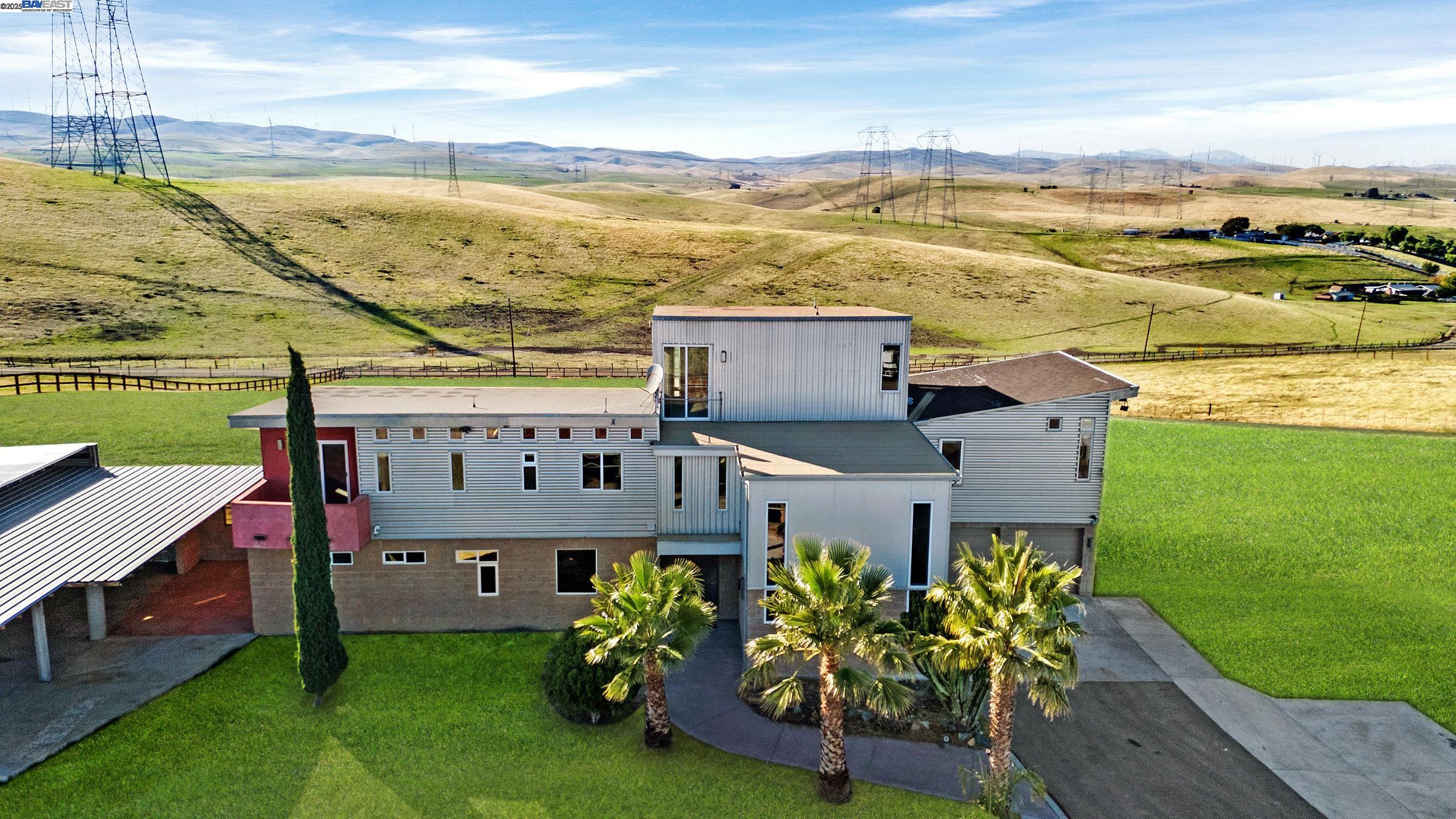 a roof deck with table and chairs and a dining table under an umbrella