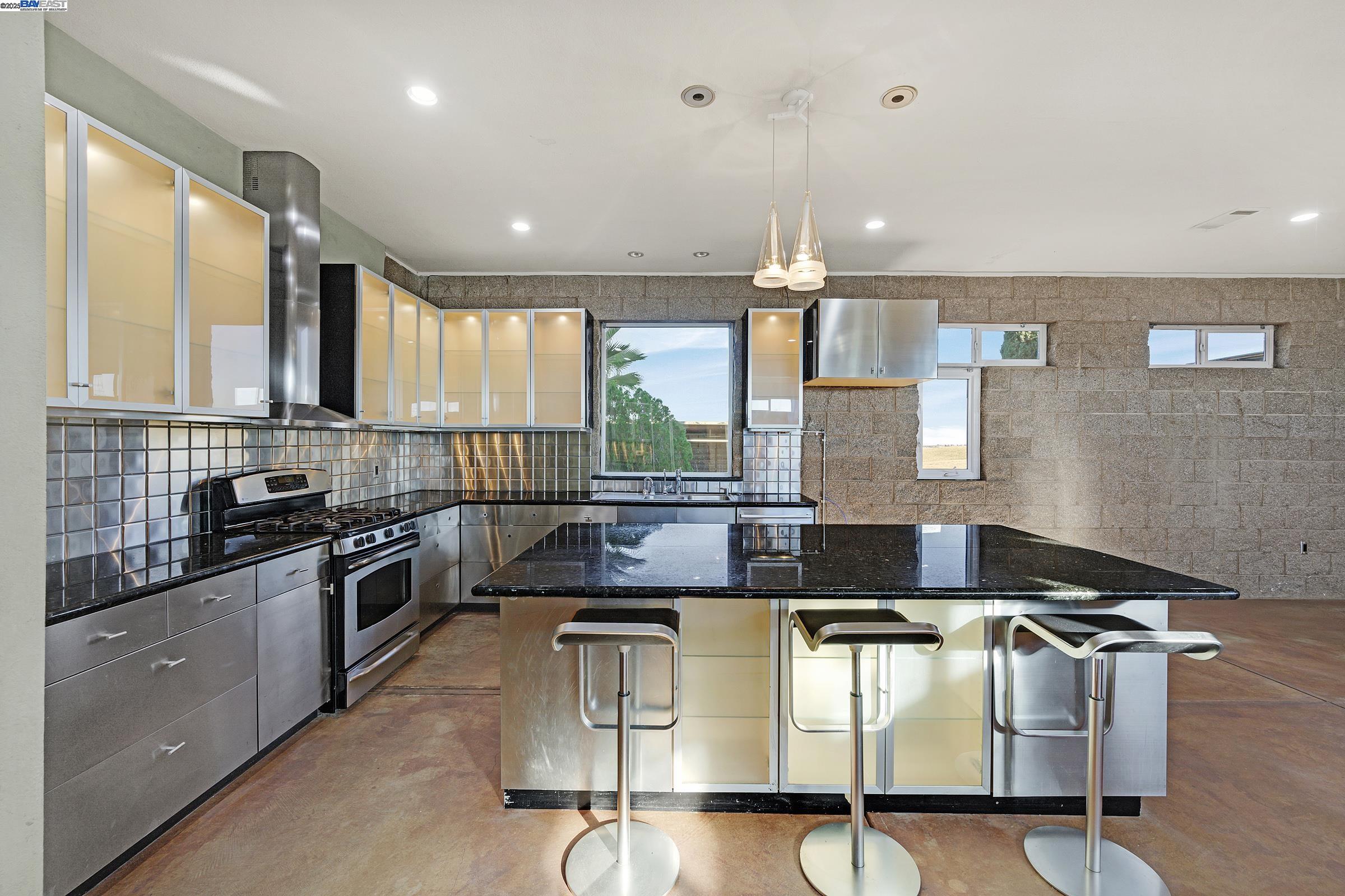 17011 North Midway Road Tracy, CA 95377 - Photo 17 of 52 a kitchen with stainless steel appliances granite countertop a stove a sink and a microwave