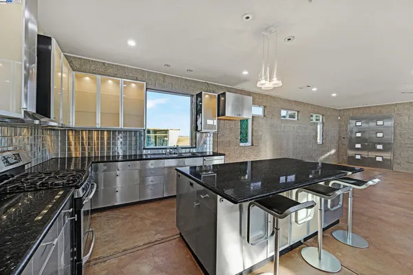 a kitchen with stainless steel appliances granite countertop a stove and a refrigerator
