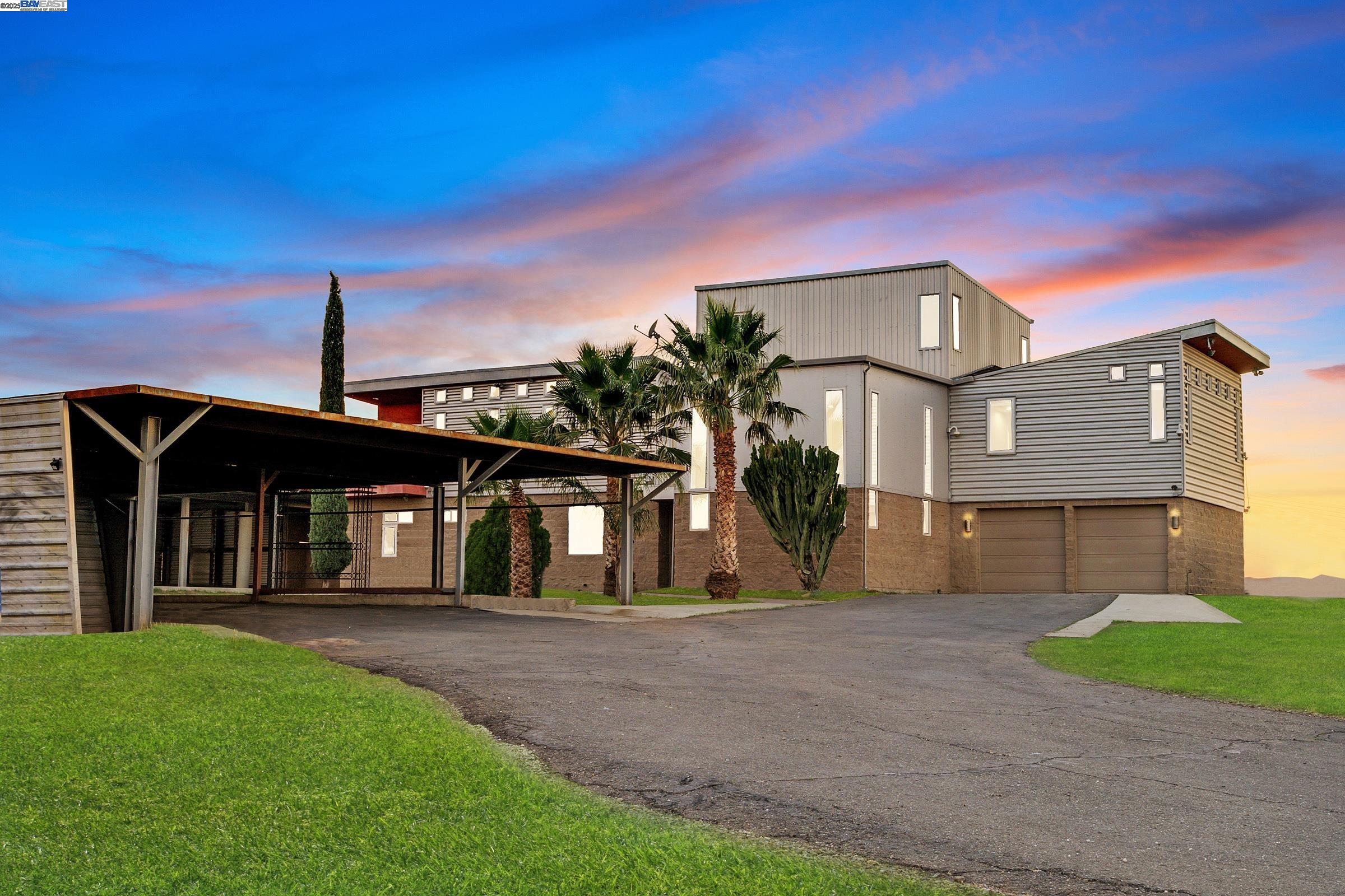 17011 North Midway Road Tracy, CA 95377 - Photo 2 of 52 a front view of a house with a garden