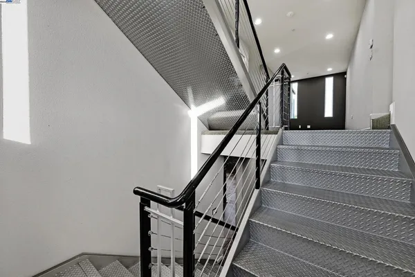 a bedroom with a bed and glass walk in closet