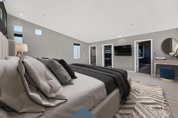 a large kitchen with granite countertop a large counter top a sink stainless steel appliances and cabinets