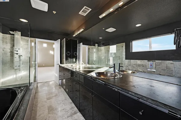 a bedroom with a bed and a flat tv screen on dresser