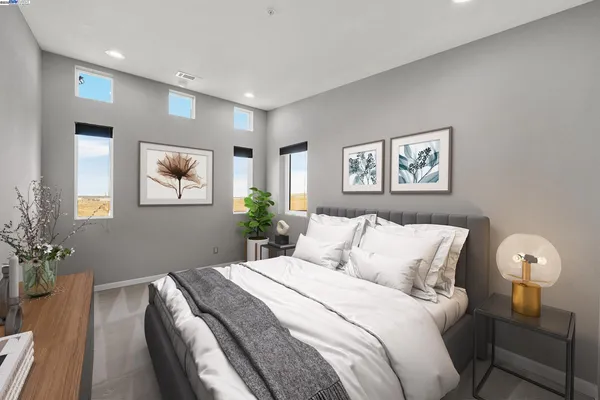 a bedroom with a bed and a potted plant