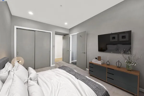a bedroom with a bed and a flat screen tv