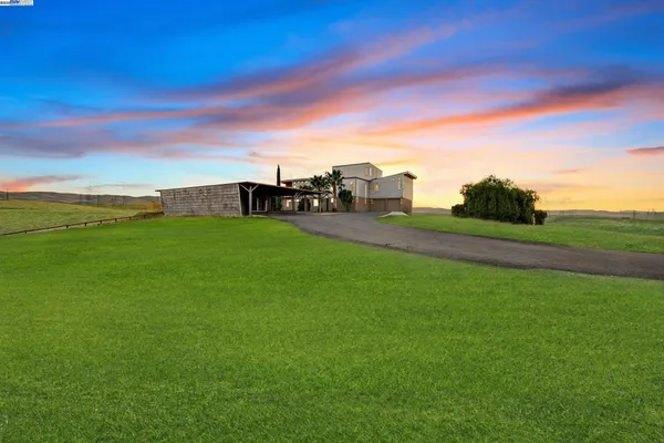 a view of a field with an ocean view