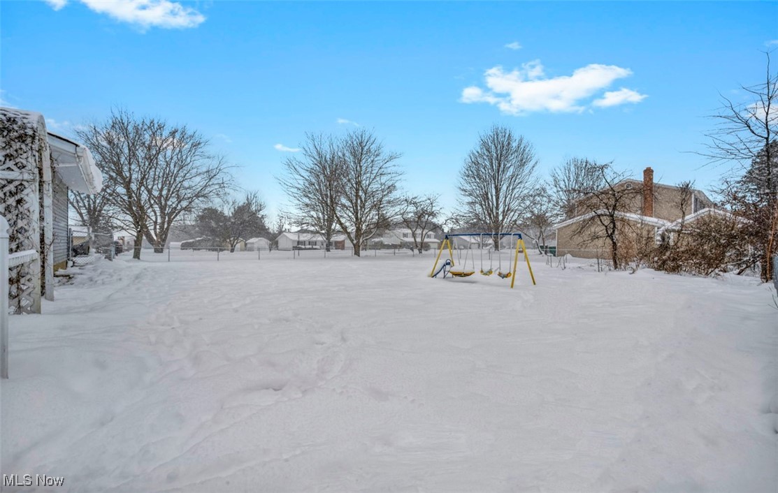 3961 Dayton Road Madison, OH 44057 - Photo 32 of 36 Yard covered in snow with a playground