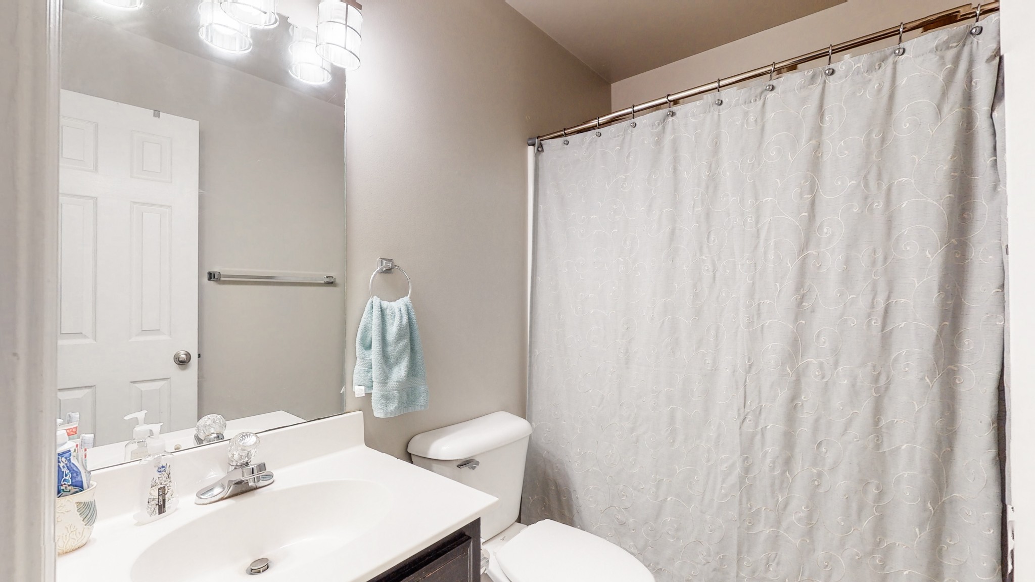 2804 Rippavilla Way Spring Hill, TN 37174 - Photo 13 of 18 a bathroom with a sink a toilet and shower curtain