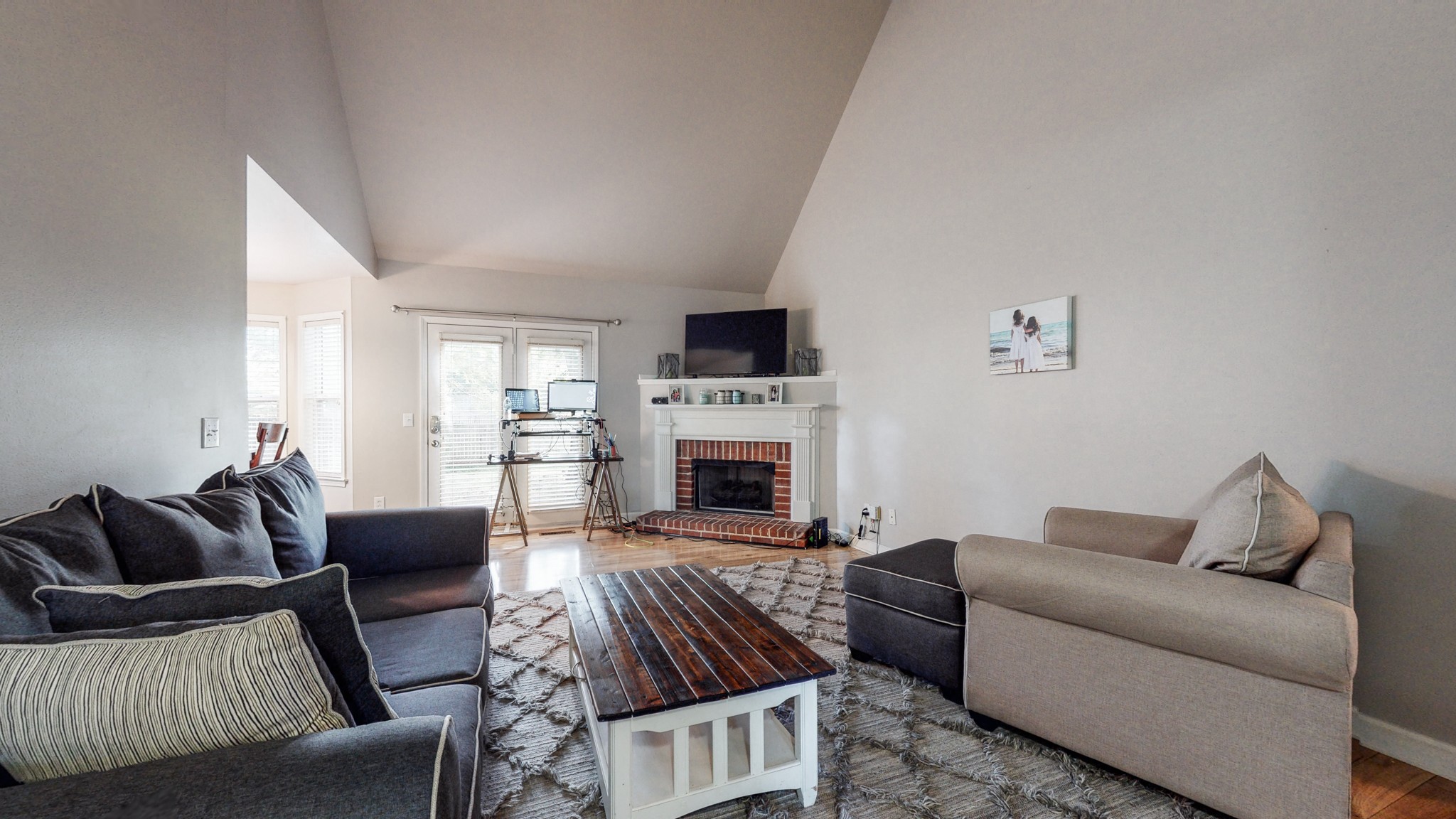 2804 Rippavilla Way Spring Hill, TN 37174 - Photo 3 of 18 a living room with furniture a flat screen tv and a fireplace
