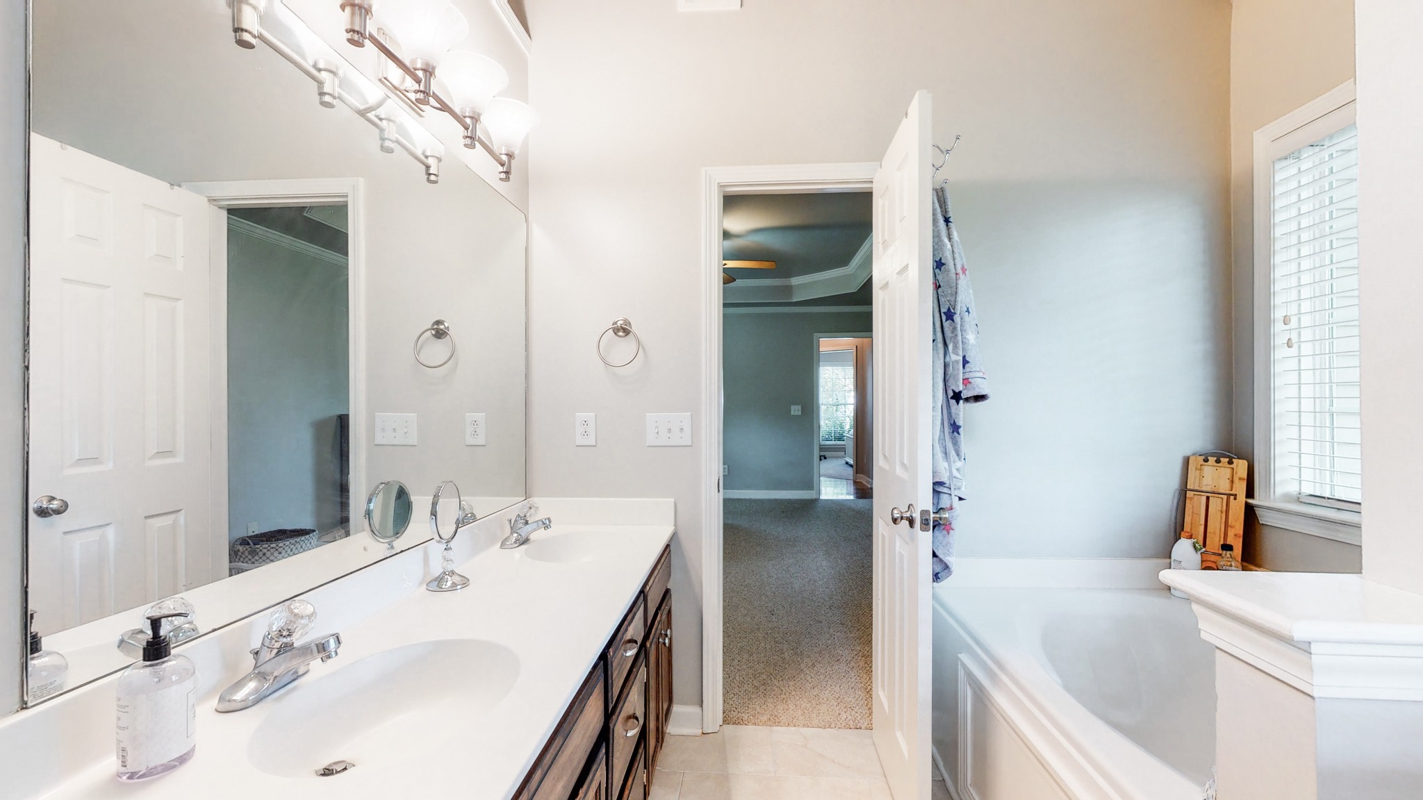 2804 Rippavilla Way Spring Hill, TN 37174 - Photo 8 of 18 a bathroom with a tub sink and mirror