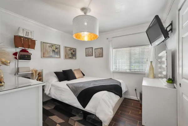 a bedroom with a bed and a chandelier