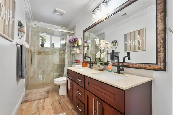 a bathroom with a sink mirror vanity and toilet