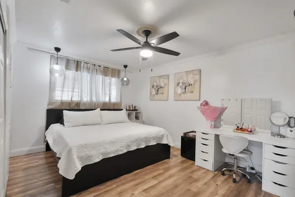a bedroom with a bed and a chandelier