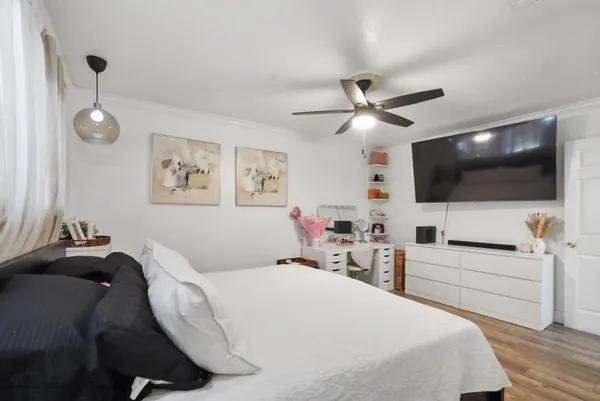 a bedroom with a bed and a flat screen tv