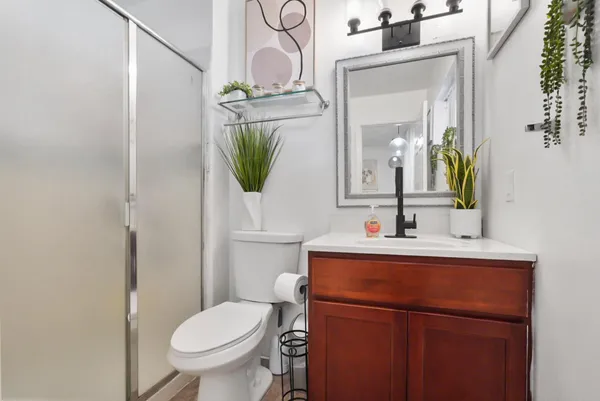 a bathroom with a toilet a sink and mirror