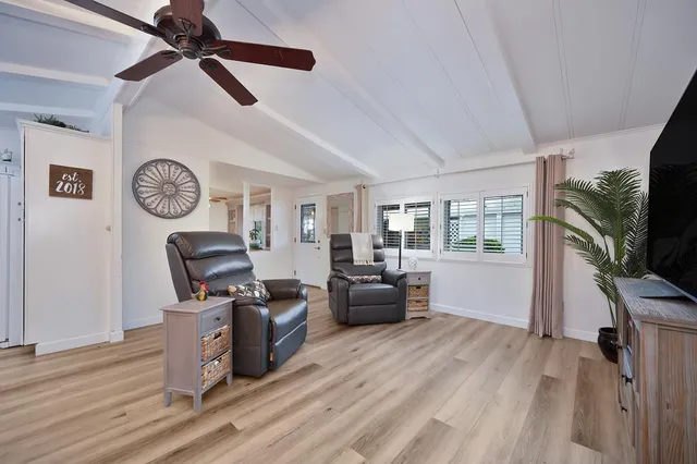a living room with furniture a window and a clock