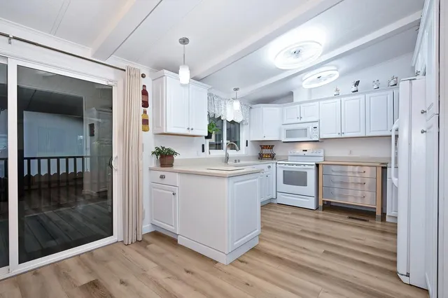 a kitchen with cabinets appliances a sink and a counter top space