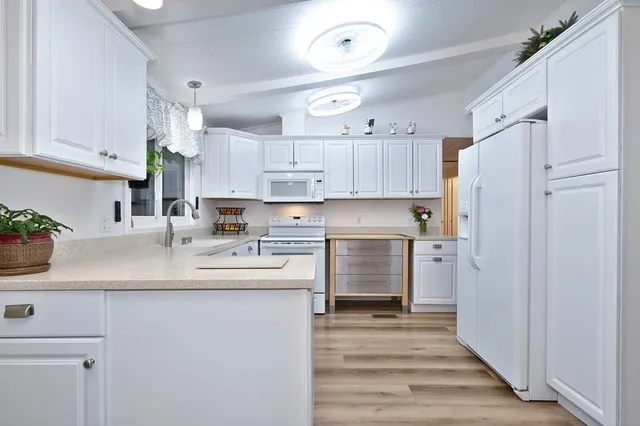 a kitchen with granite countertop a white cabinets and a stove