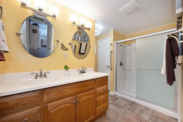 a bathroom with a double vanity sink and a mirror