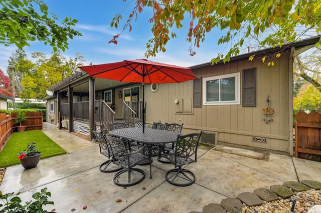 a view of a patio with a table and chairs under an umbrella
