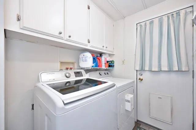 a view of a patio with a table and chairs under an umbrella