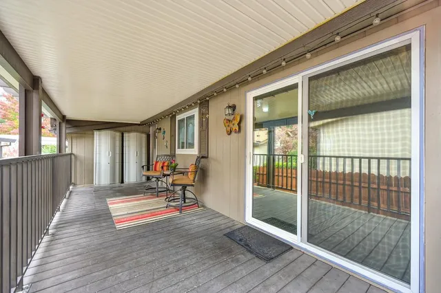 a view of patio with chairs and table under an umbrella