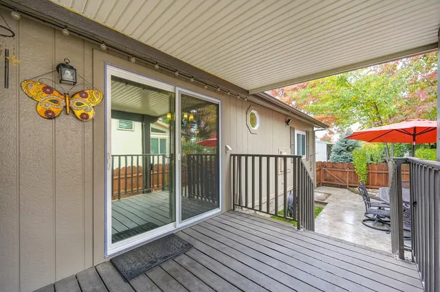 a white house that has a tree in front of it