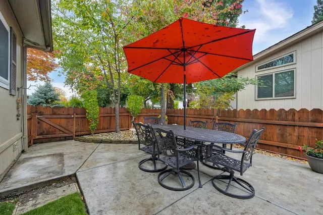 a view of a house with a yard and sitting area