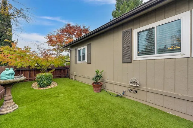 a backyard of a house with table and chairs