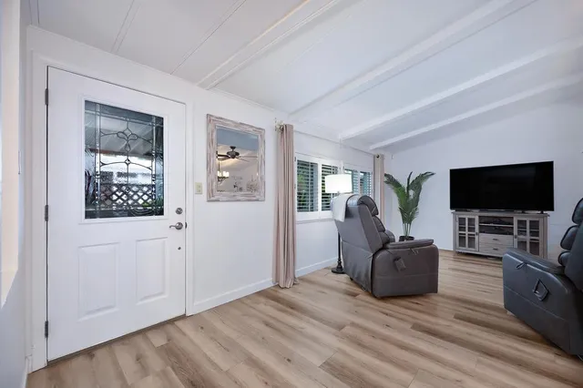 a view of livingroom with hardwood floor and workspace