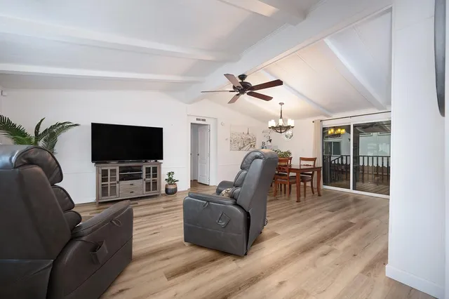 a view of workspace with wooden floor windows fan and windows