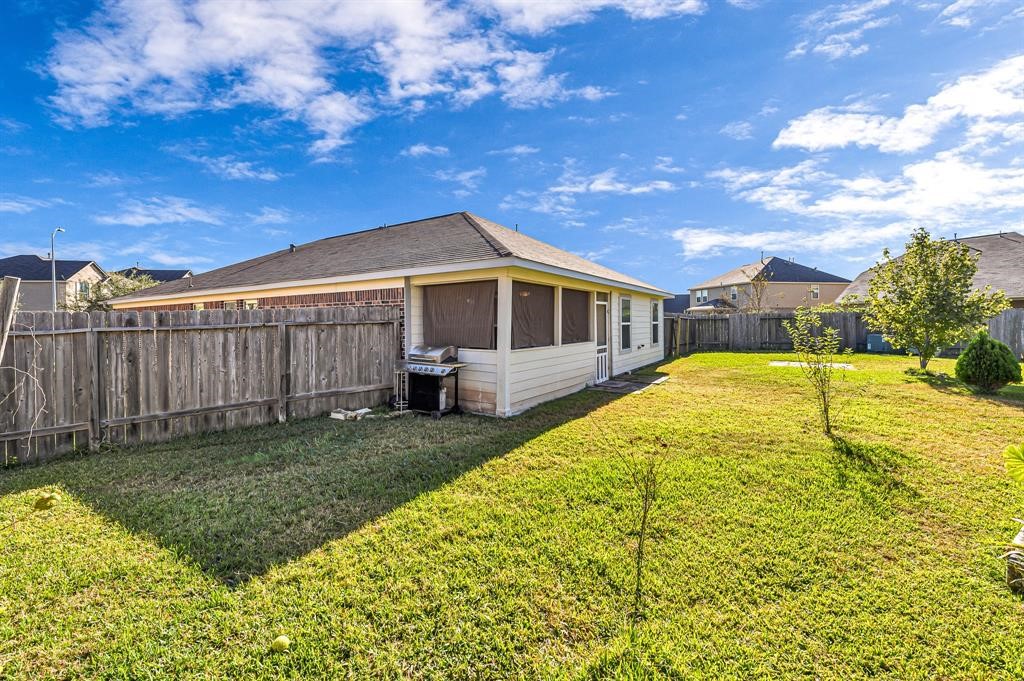 3203 Dale Ridge Trail Houston, TX 77084 - Photo 30 of 33 Expansive, fully fenced backyard with a wood privacy fence, offering plenty of open green space for pets and play.