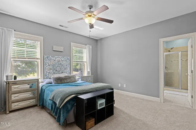 a bedroom with a bed and a ceiling fan