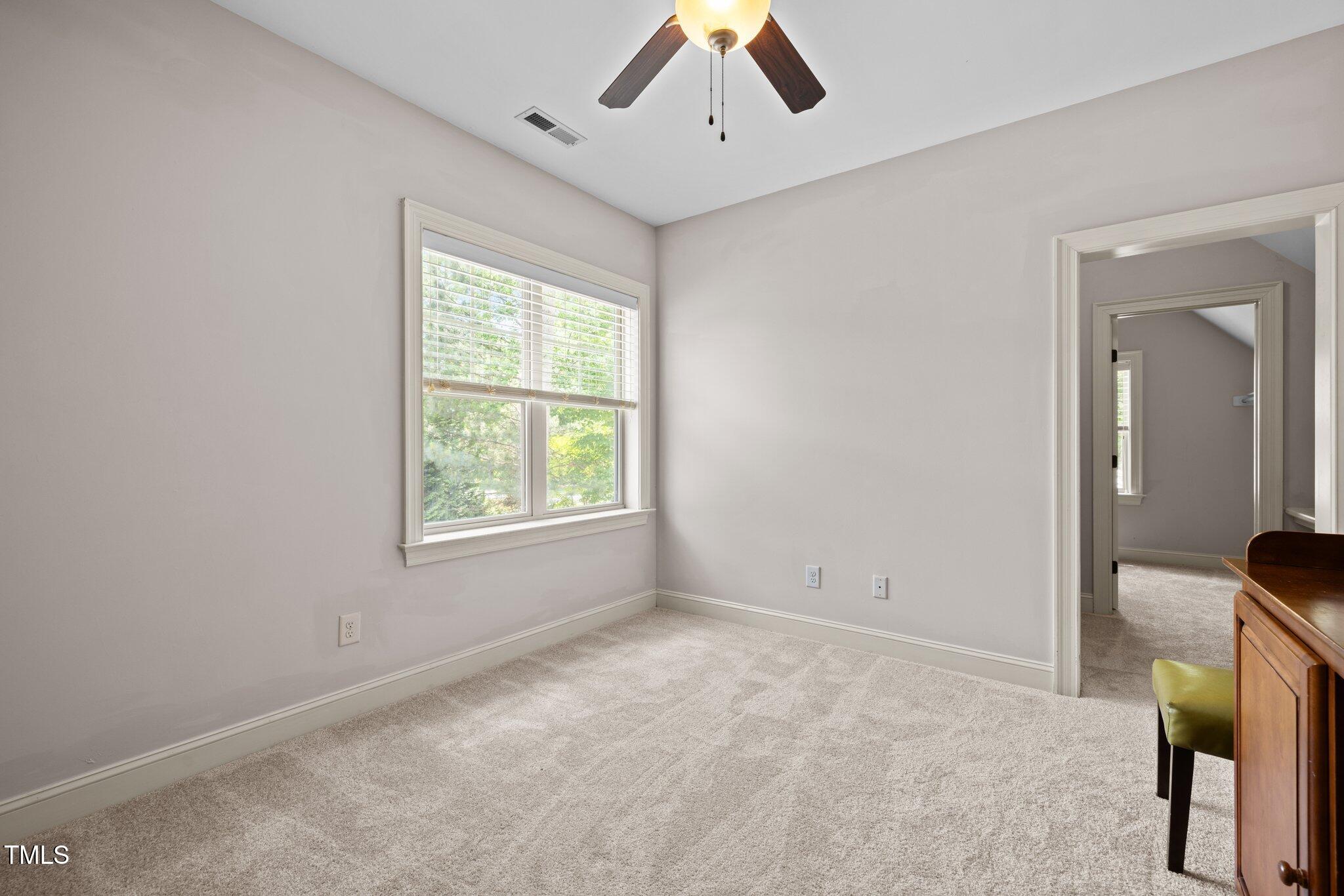 12216 Kyle Abbey Lane Raleigh, NC 27613 - Photo 23 of 60 a view of an empty room with a window