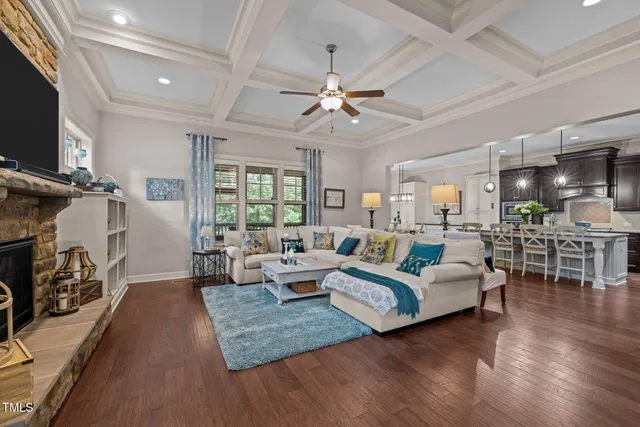a living room with furniture fireplace and flat screen tv