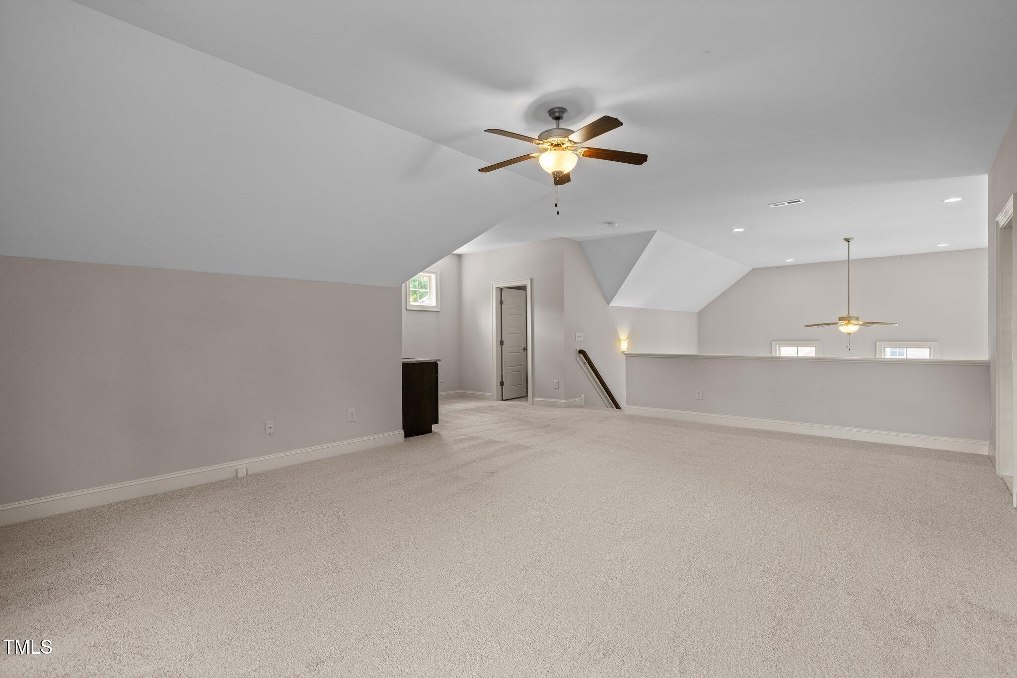 12216 Kyle Abbey Lane Raleigh, NC 27613 - Photo 31 of 60 an empty room with a ceiling fan and window