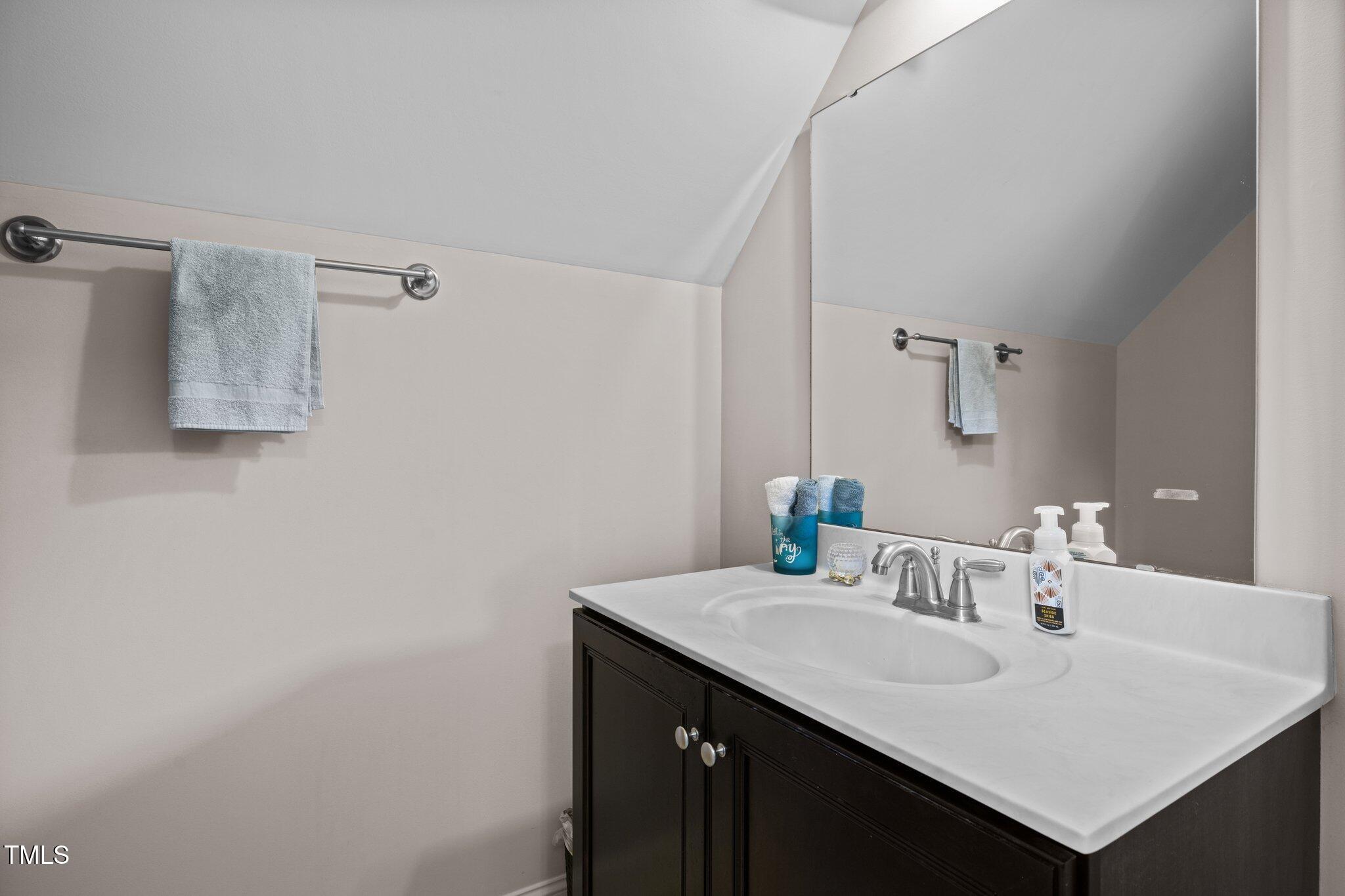 12216 Kyle Abbey Lane Raleigh, NC 27613 - Photo 33 of 60 a bathroom with a sink and a mirror