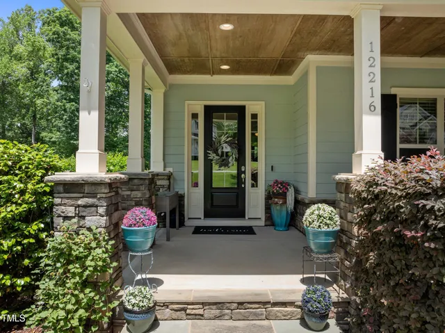 a backyard of a house with yard fire pit and outdoor seating