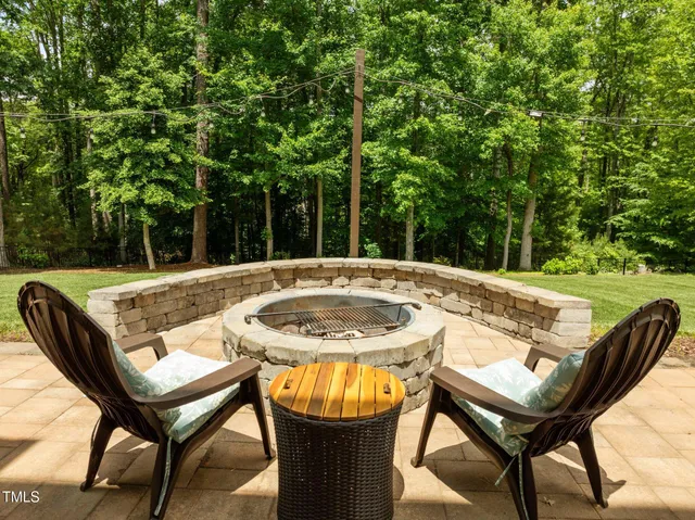 a backyard of a house with table and chairs