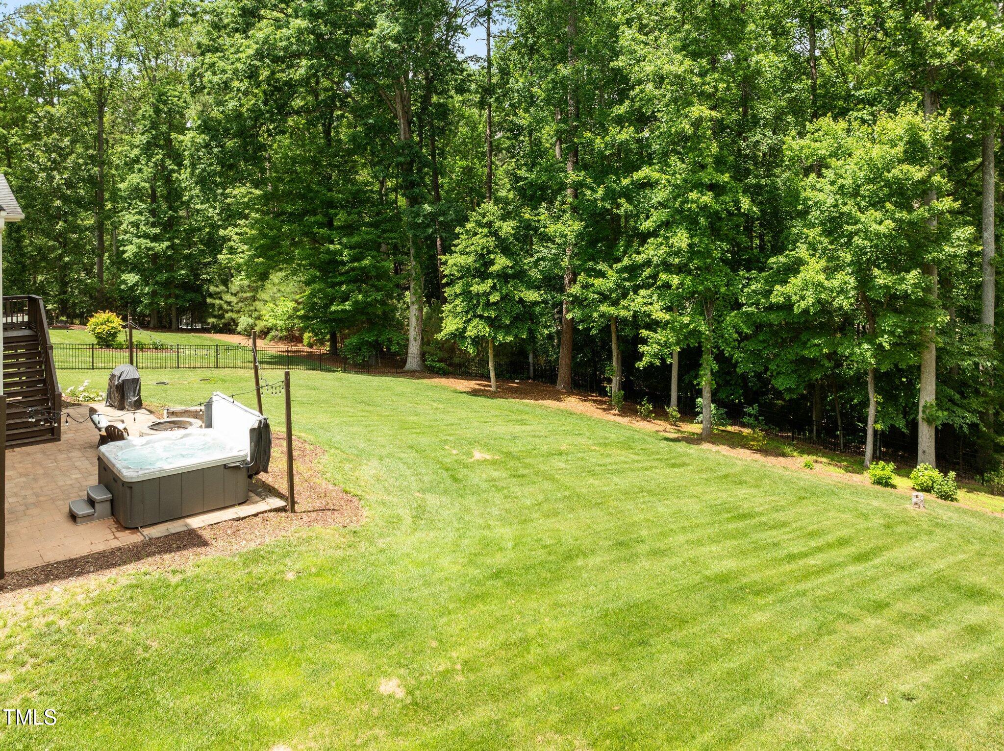 12216 Kyle Abbey Lane Raleigh, NC 27613 - Photo 46 of 60 a backyard of a house with table and chairs