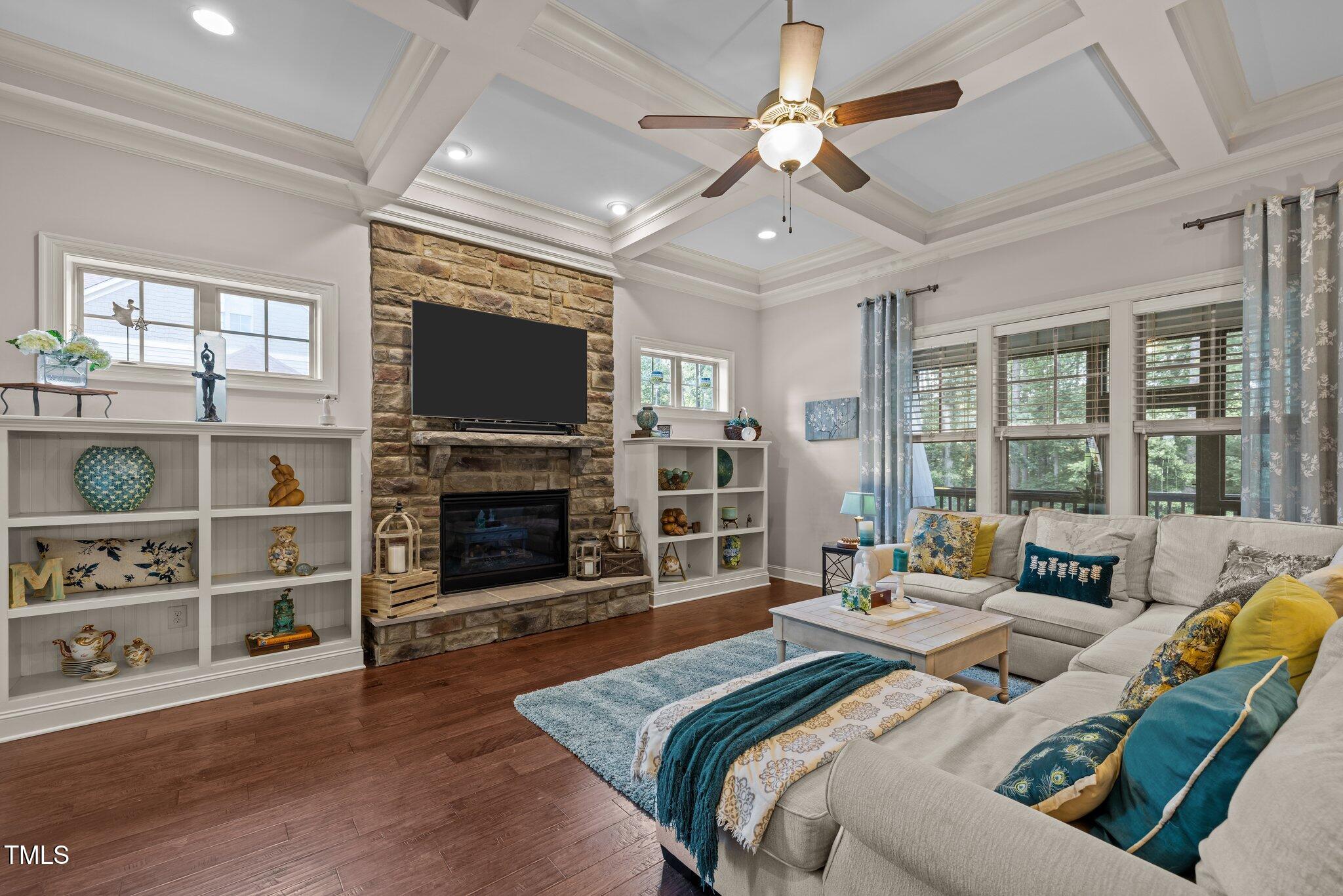 12216 Kyle Abbey Lane Raleigh, NC 27613 - Photo 3 of 60 a living room with furniture a fireplace and a flat screen tv