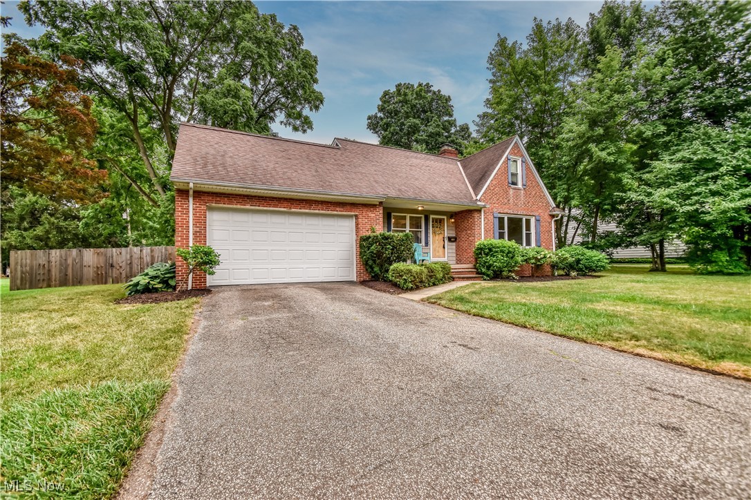 8115 Stockbridge Road Mentor, OH 44060 - Photo 2 of 46 View of front facade featuring asphalt driveway, brick siding, a garage, and roof with shingles