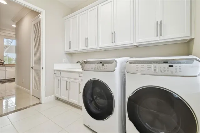 a kitchen with stainless steel appliances kitchen island granite countertop a refrigerator a stove and a sink