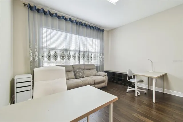 a dining room with furniture a chandelier and wooden floor