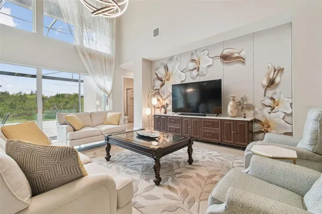 a spacious bedroom with a large bed and a flat tv screen on dresser