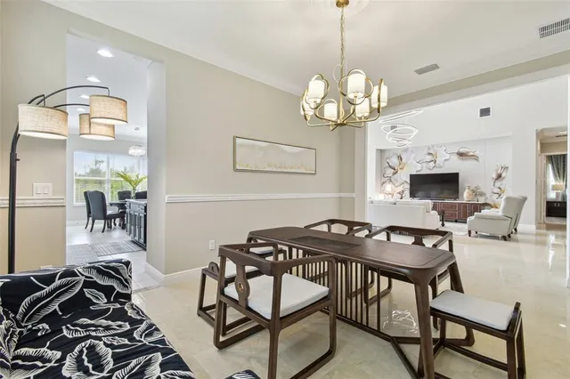 a bedroom with a bed and a chandelier fan