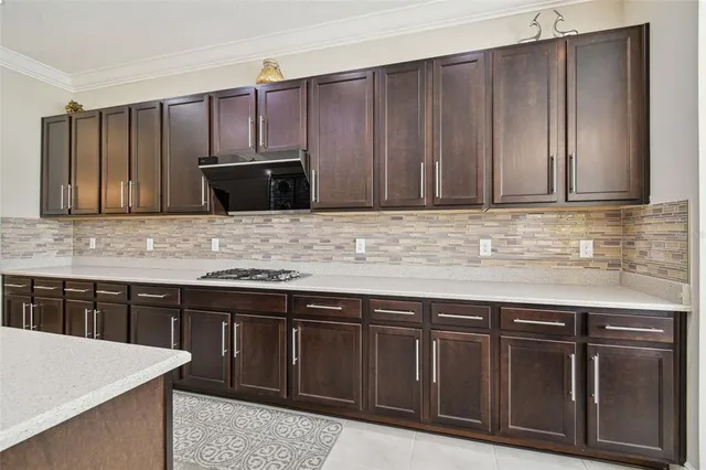 a bathroom with a granite countertop sink a toilet and a bathtub