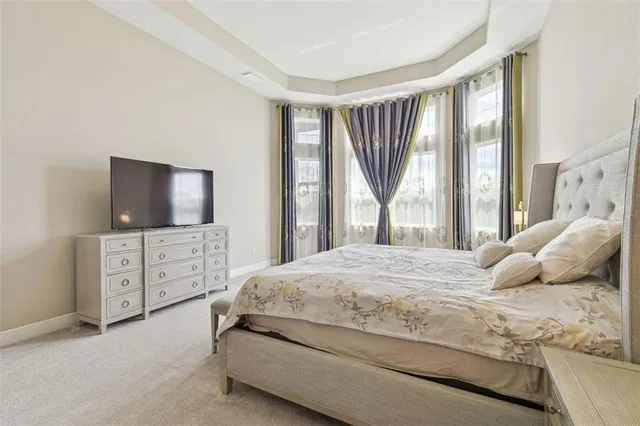 a spacious bedroom with a bed and a couch