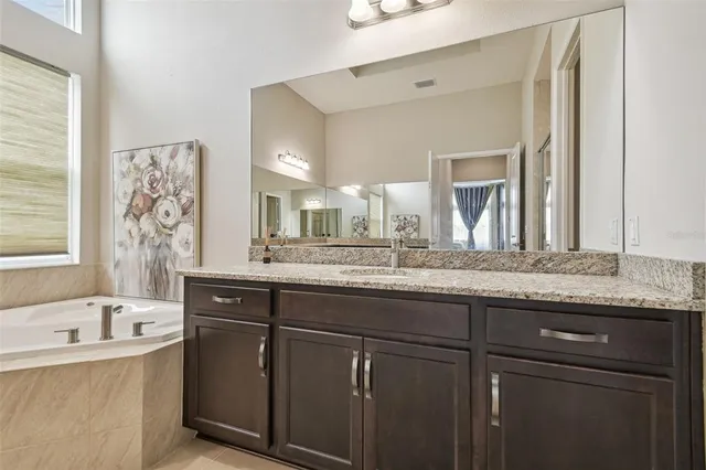 an aerial view of a house with garden space and lake view